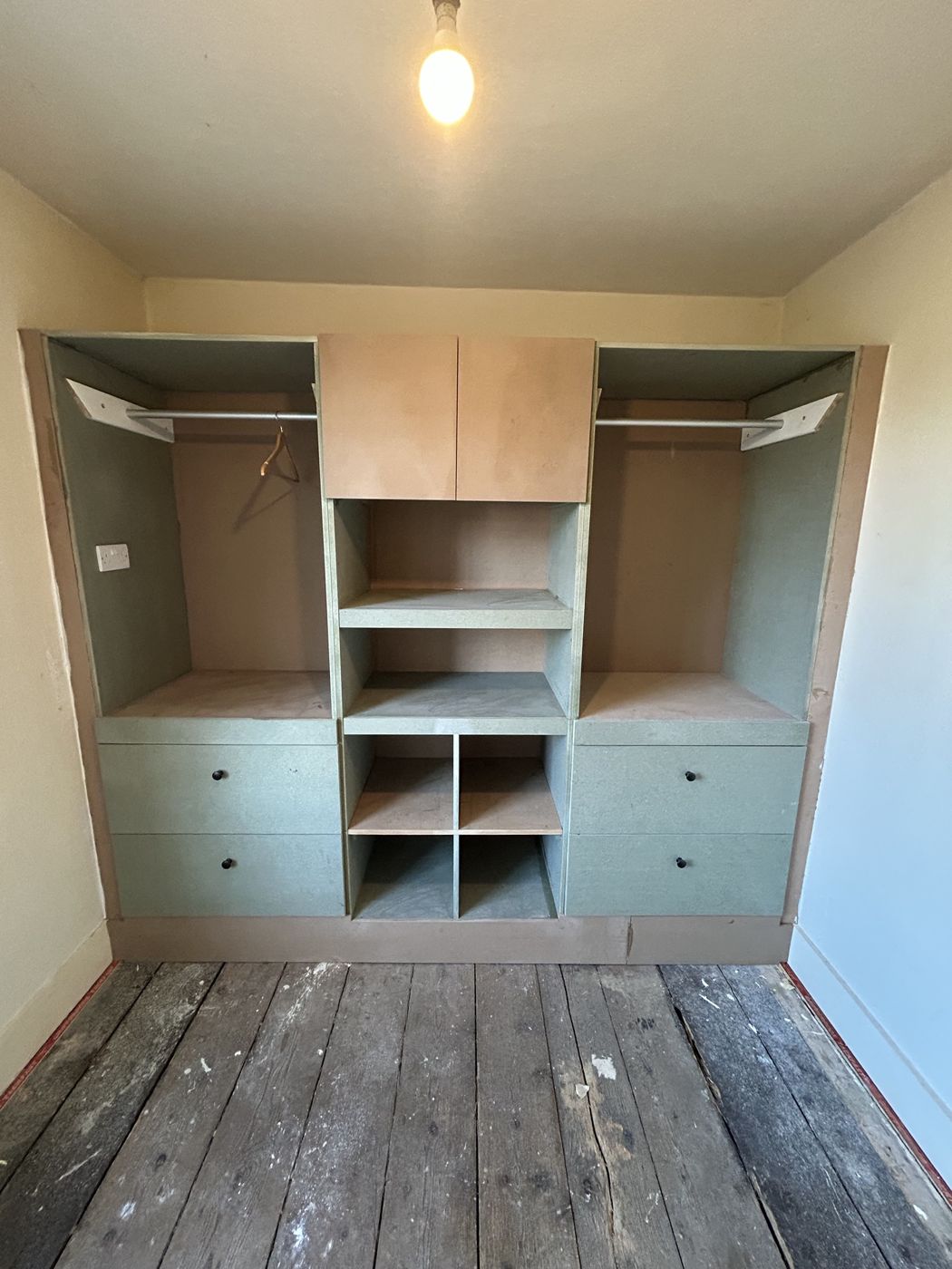 Bespoke fitted wardrobe with hanging rails, shelving, cubbies and drawers